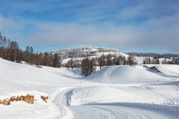 Road in the Altai mountains on a sunny frosty winter day. Altai Republic, Siberia, Russia