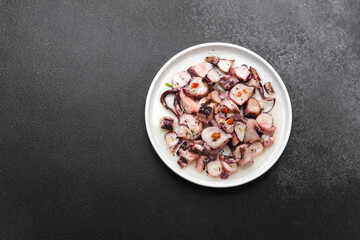 Octopus salad on white  plate for Mediterranean cuisine or healthy seafood concept