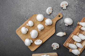 Variety of mushrooms including king oyster, shimeji and button on cutting boards for recip