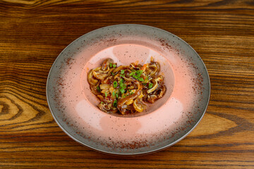 marinated pig ears on a plate with greens