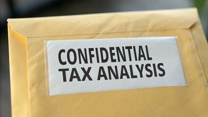 Obraz premium tax+rate+debate Confidential envelope labeled for tax analysis, suggesting privacy and financial matters.