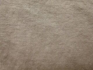 close-up texture of soft beige fabric with subtle weave pattern, ideal for home decor, upholstery, or textile design projects