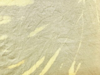 light yellow textured fabric with subtle wrinkles soft tones for textile design or background use