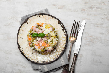  Traditional Russian salad Olivier for the New Year's table on white wooden background top view