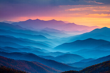Sunrise over layered mountain ridges with warm tones