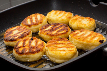 Traditional Russian sweet syrniki cottage cheese pancakes fried in the frying pan