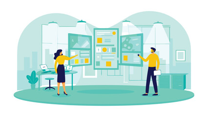 Two people presenting data on multiple screens in a modern office environment with computers and plants