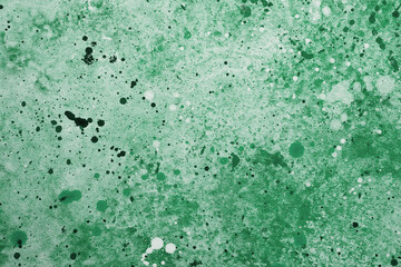 Abstract green splatter artwork created with various paint techniques