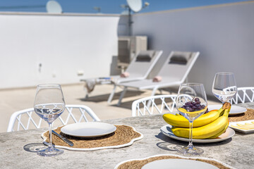 Rooftop Dining Table with Fresh Fruit and Lounge Chairs