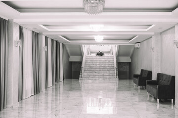 Elegant hallway showcasing a staircase and modern seating in a hotel lobby