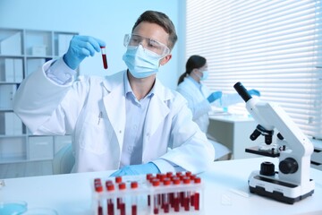 Medical analysis. Scientist working with blood sample in laboratory, selective focus