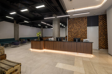 Modern hotel reception interior with decorative wooden wall