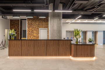 Modern hotel reception with wooden wall