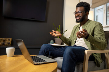 Young businessman having a video call and looking involved