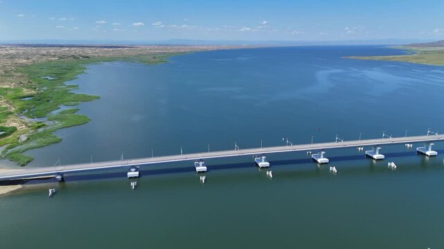 Aerial footage of Kazakhstan's longest bridge (1316 m) crossing Bukhtarma Reservoir in East Kazakhstan Region. Captured in daylight with a drone.4K, 30fps