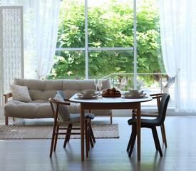 Beautiful table setting, chairs and decor in dining room. Interior design