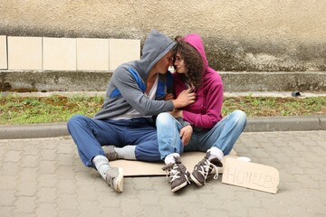 Poor people on carton and sign Homeless outdoors