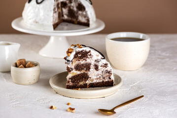 Piece of Pancho Cake. Homemade vegan biscuit cake with sour cream, pineapple and cup of coffee on a white table. Sugar, lactose and gluten free.