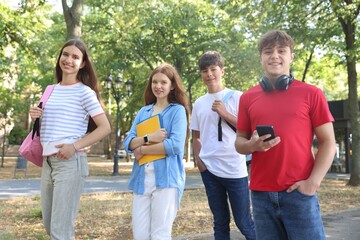Group of teenagers walking together in park