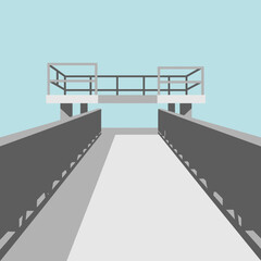 Concrete structure with railings over a walkway against a light blue background.