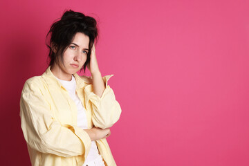 Woman suffering from hangover on crimson background, space for text