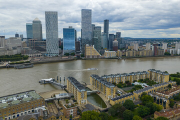 Aerial image showing Canary Wharf towers behind riverfront residential buildings and mooring dock.