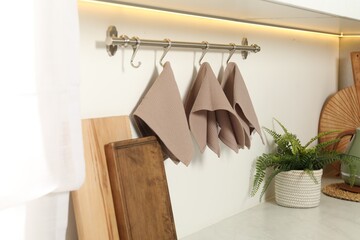 Clean waffle towels hanging on hook rack in kitchen