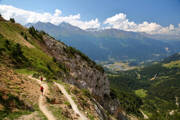 A hiking trail leading to La Turra, surrounded by mountains and overlooking the Maurienne Valley and the village Aussois, Savoie, Northern French Alps, France