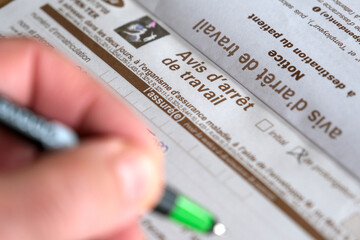 French medical leave form being filled out by hand, highlighting a notice of work stoppage for...