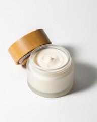 Cream Jar: A glass jar, its wooden lid gently ajar, cradles a swirl of luxurious cream, exuding a sense of natural beauty and skincare