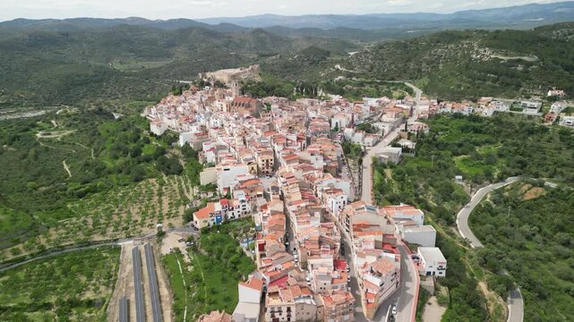 Aerial view of Cervera del Maestre, a historic town nestled amongst rolling hills, a captivating blend of terracotta roofs and green landscapes, Cervera del Maestre, Valencian Community, Spain.
