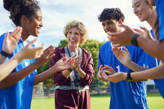 Female coach encourages sport team before the game