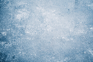 Grunge blue plaster wall with weathered texture and mottled pattern