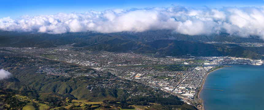 Lower Hutt, Wellington, New Zealand. Panoramic aerial view. Hutt River flows out to sea above Petone Beach at far right. Wainuiomata over the hill at top right.