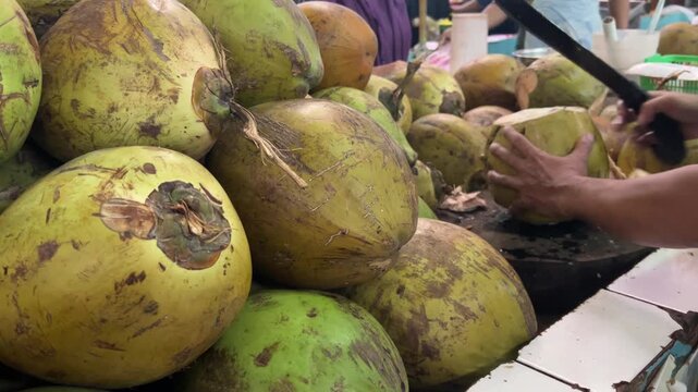 video of hand cutting the coconut in the market