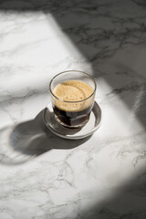 Black hot coffee in a glass, sunlight, lifestyle photo