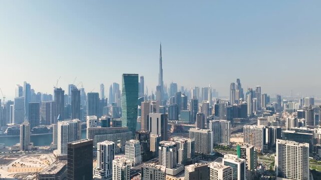 Dubai, United Arab Emirates - 08 January 2025: Aerial view of Dubai's skyline, showcasing modern skyscrapers and the iconic Burj Khalifa against a clear sky.