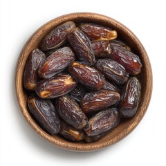 Dried dates in a wooden bowl, top view