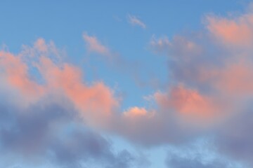 Fototapeta premium Soft, pastel-hued clouds against a vibrant blue sky