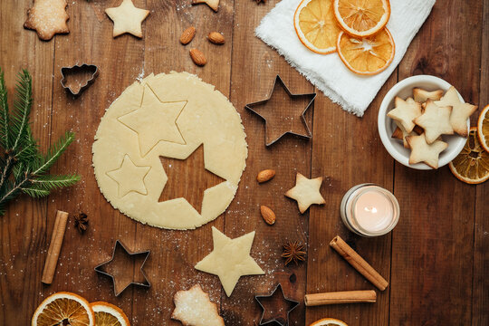 Christmas cookie dough cutting with star shapes and tree cookies for holiday food and festive baking concept