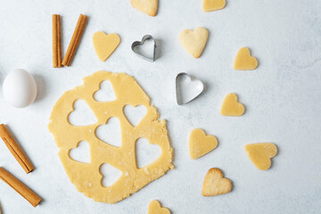 Heart cookies and cinnamon with raw baking dough for romantic, food styling or valentines concept in stock photography