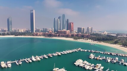 Dubai, United Arab Emirates - 01 August 2025: Aerial view of the marina with boats, beaches, and the city skyline of Dubai, displaying a vibrant coastal scene.