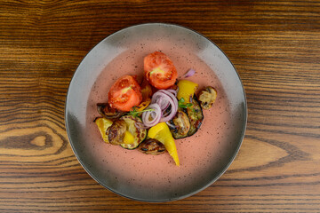 fried zucchini with peppers and tomatoes on a plate