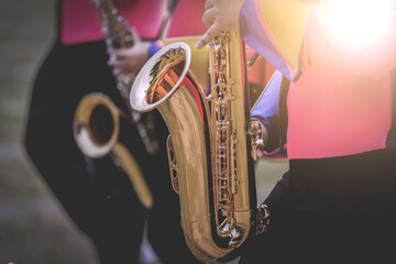 Musical instruments in a marching band, saxophone playing hands, saxophone playing jazz. Alto...