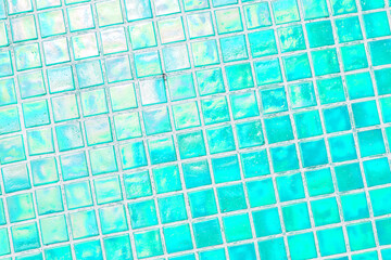 Mosaic of scratched glass tiles as a decorative element in architecture. Antique square turquoise...