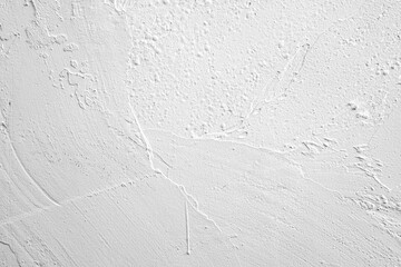Surface texture details on a white wall showcasing unique patterns and marks