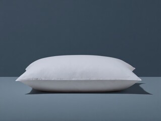 Relaxing white pillow on minimalist blue background home decor still life modern aesthetic close-up view comfort concept