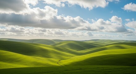 Obraz premium Bright Sunlight on Rolling Green Hills and Blue Sky