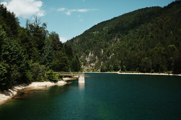 A calm Kruscica lake surrounded by dense forest and mountains in Tara National Park, Serbia. A...
