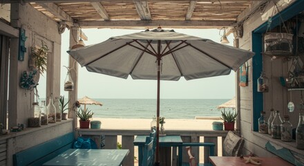 Fototapeta premium Beachfront Restaurant with Ocean View and White Umbrella